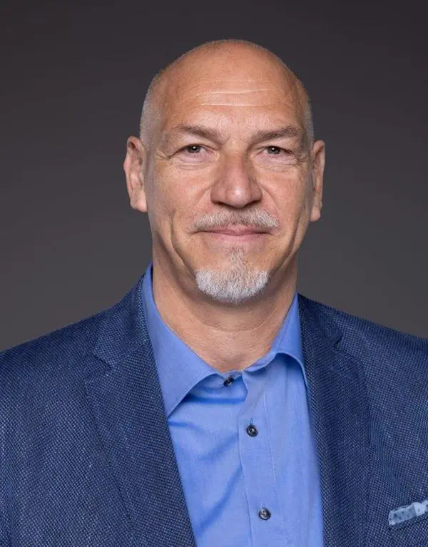 Portrait von Oliver Wolkenhauer, Immobilien Makler aus Tostedt, im blauen Anzug mit blauem Hemd.